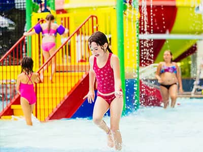 Child playing in the Splash Valley sprayground.