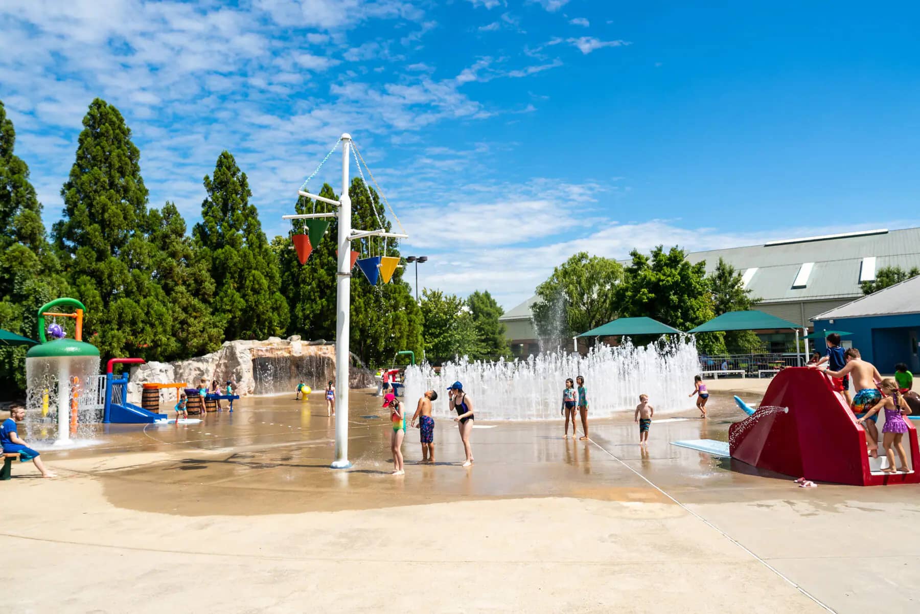 Wide view of South Germantown SplashPark with multiple water features and open spray areas.