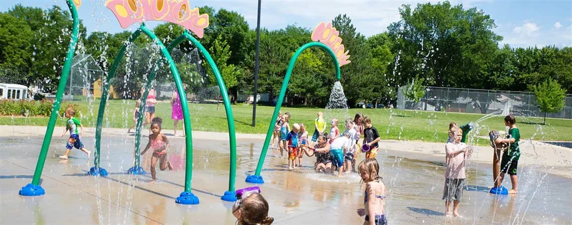 Pioneer Splash Pad in Sioux Falls with dinosaur-themed spray features.