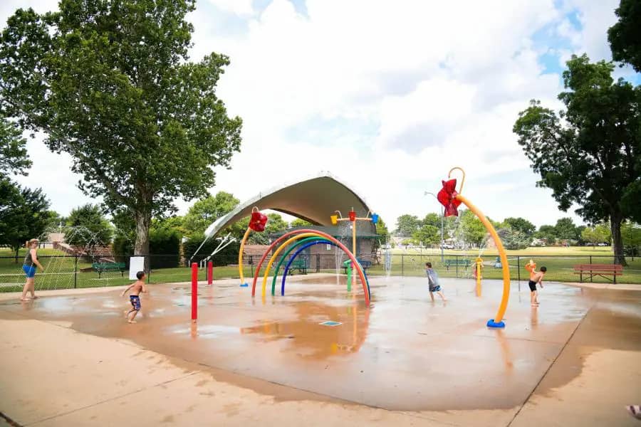 Andrews Park Splash Pad in Norman with ground sprays and open splash area.