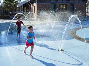 Daytime view of Imagination Fountain at Cascades Park with children's ground jets in Tallahassee.