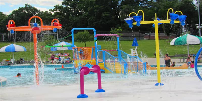 Children playing in the spray area at William L. Welch Community Pool in State College.