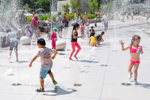 Children playing at the water feature in Mosaic Park, Arlington.