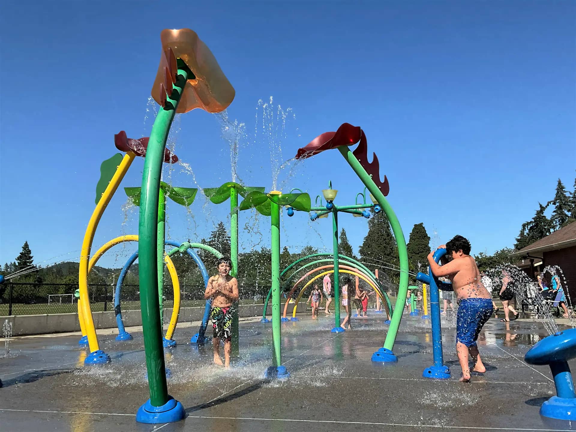 Children playing at Fir Grove Park Splash Pad in Roseburg.