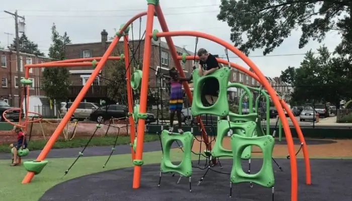 Children enjoying updated playground equipment at Roosevelt Playground, which also includes a sprayground.