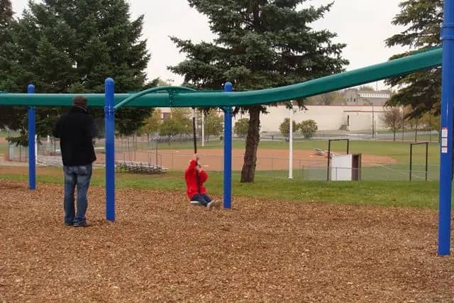 Families visiting North Park in New Ulm, including the playground and splash pad area.
