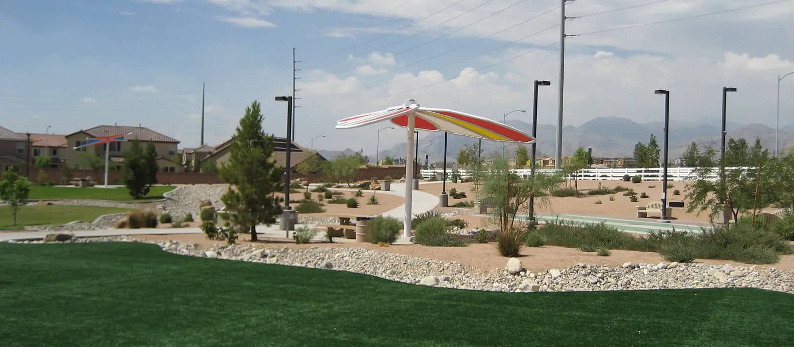 Gilcrease Brothers Park with shaded family park features and water play area.